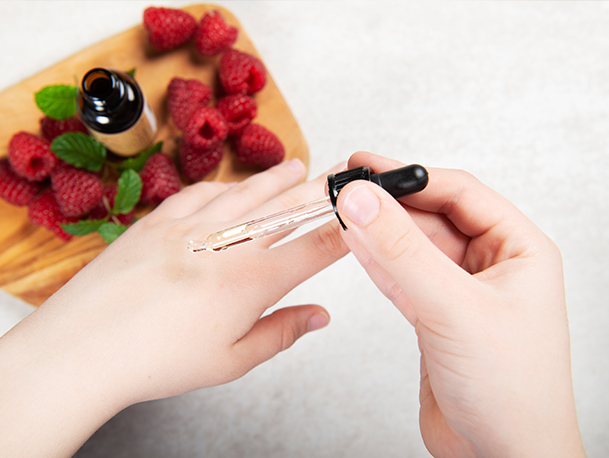 Raspberry seed oil being applied to hands